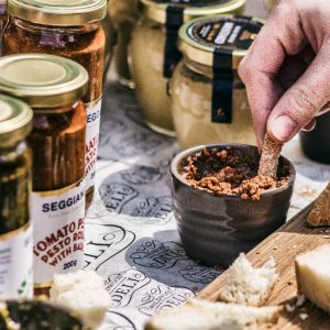 Bread being dipped into pesto